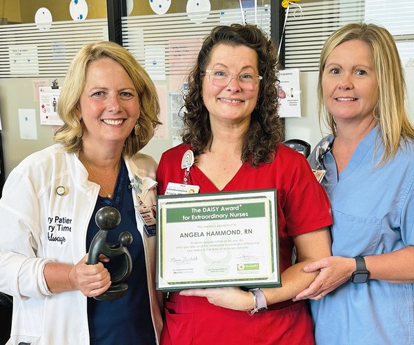 Angela Hammond, RN, Cardiac Rehab Program Coordinato, center, shows off her DAISY top nursing award with members of the cardio team at East Georgia Regional Medical Center.