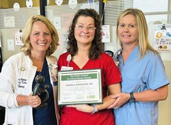 Angela Hammond, RN, Cardiac Rehab Program Coordinato, center, shows off her DAISY top nursing award with members of the cardio team at East Georgia Regional Medical Center.