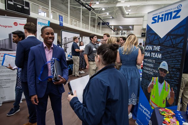 Cade Willis, a management and finance major from Loganville, left, chats with HR Generalist Marie Colon of Shimizu North America during the event.