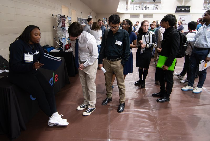 Raynisha Frazier, a Google software engineer recruiter and Georgia Southern Alumnus takes a look at the resume of computer and electrical engineering double major Blake Edelman of Las Vegas as fellow students wait in line for their turn during the activit