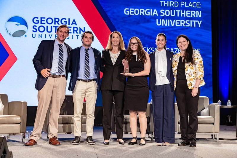 The students are shown below accepting their third-place honor.