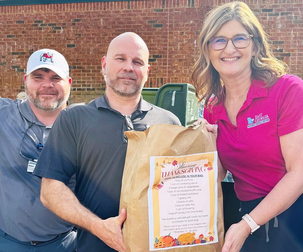 Plant Operations Engineer Allen Brannen; Bio Med Engineer Pat Patterson and Hospitalist Manager Mandy Fowler help load Thanksgiving meal bags that were donated to Christian Social Ministries.