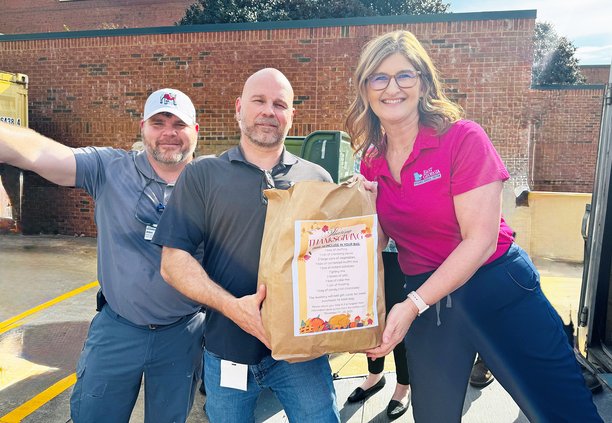 Plant Operations Engineer Allen Brannen; Bio Med Engineer Pat Patterson and Hospitalist Manager Mandy Fowler help load Thanksgiving meal bags that were donated to Christian Social Ministries.