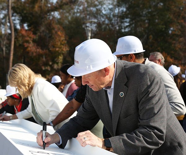 Technical College System of Georgia Commissioner Greg Dozier joined Ogeechee Technical College President Lori Durden last week in signing one of the last beams that will be installed in the Georgia Training Center for Industrial Operations building under