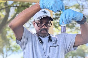 A volunteer with “Safe Water Together for Brunswick” tests water as part of a program organized by Georgia Southern University’s Institute for Water and Health.