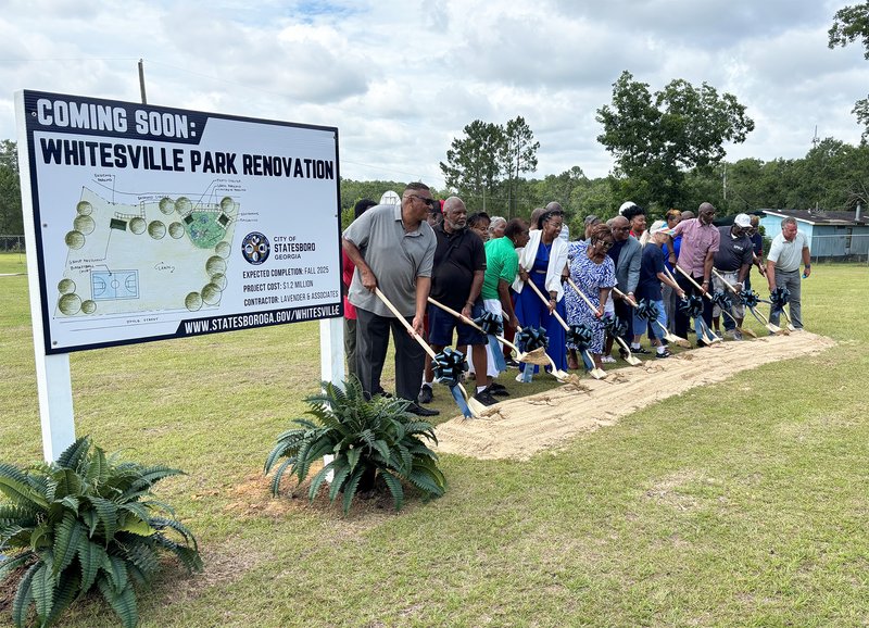 Statesboro city officials, along with members of the Whitesville community, joined Caroll Hunter, center in blue dress, the daughter of the late Carrie Howard, in turning the ceremonial first shovel of dirt at Wednesday’s groundbreaking for renovations to
