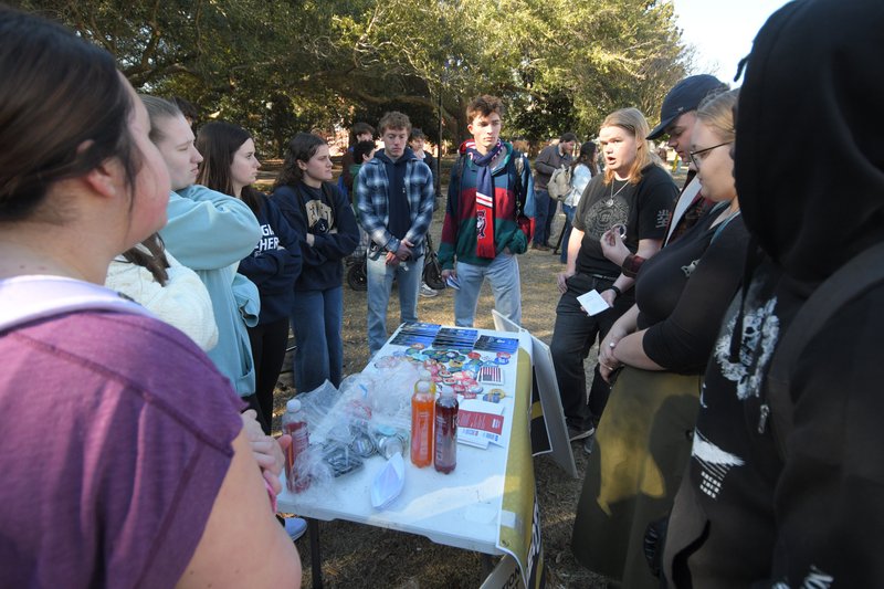 After some initially heated exchanges, members of the campus chapter of Turning Point USA, left, and participants in Wednesday's protest against ICE exchange ideas and debate the issues as the demonstration winds down.