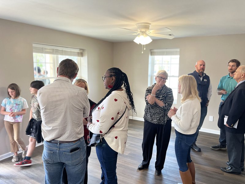 H Community members gather in anticipation of homeowners' entrance into her new home.jpg