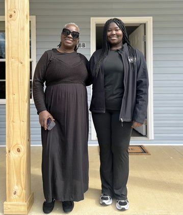 H Lola Harris and daughter, Jayden President strike a pose in front of their new home..jpg