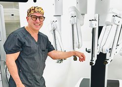 Photo Courtesy East Georgia Regional Medical Center Thomas Sorbera, M.D., a urologist with East Georgia Urology, is photographed with the robotic equipment that allows precise removal of prostate tissue.