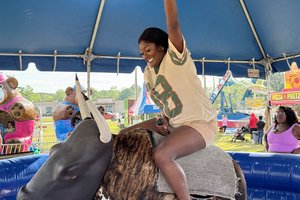 at the 2025 Carnival, Tapeka Arnett gives it her best shot to stay on the mechanical bull. Arnett came to Statesboro to attend Georgia Southern  in 2015 and never left.