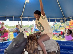 at the 2025 Carnival, Tapeka Arnett gives it her best shot to stay on the mechanical bull. Arnett came to Statesboro to attend Georgia Southern  in 2015 and never left.